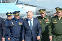  Vladimir Putin, surrounded by top military officers and officials, tours a military flight test centre in Akhtubinsk on May 14, 2019. ALEXEY NIKOLSKY/AFP via Getty Images 