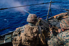 PHILIPPINE SEA (Feb. 20, 2021) Marine machine gun teams fire 50-cal and M240 machine guns during a live-fire gunnery training exercise aboard amphibious transport dock ship USS New Orleans (LPD 18)