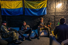 Ukrainian soldiers rest in Kyiv, Ukraine, after their day fighting out on the front lines north of the capital on Monday.Credit...Daniel Berehulak for The New York Times