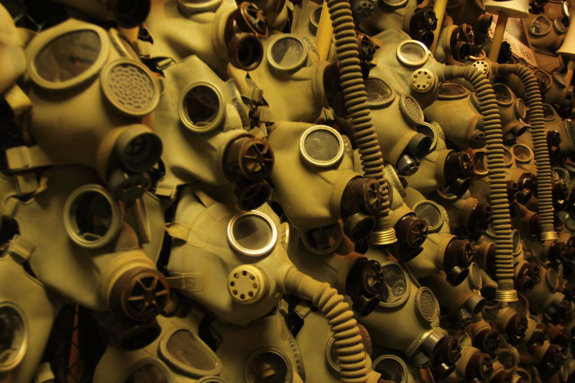 A wall of gas masks.