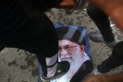 Protesters trample a portrait of Iran’s supreme Leader Ayatollah Ali Khamenei during the storming and burning of the Iranian consulate in Basra, southeast of Baghdad, last week. (Nabil al-Jurani/AP)