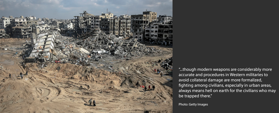 People wander through the devastated area near the al-Maqoussi towers in the aftermath of an Israeli bombardment in Gaza City on Feb. 3