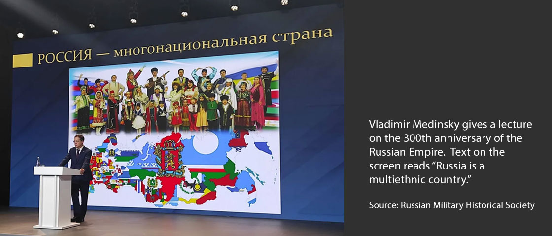 Vladimir Medinsky gives a lecture on the 300th anniversary of the Russian Empire.  Text on the screen reads “Russia is a  multiethnic country.”