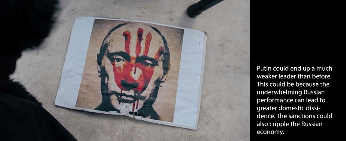Printed/painted picture of Putin with red handprint on face