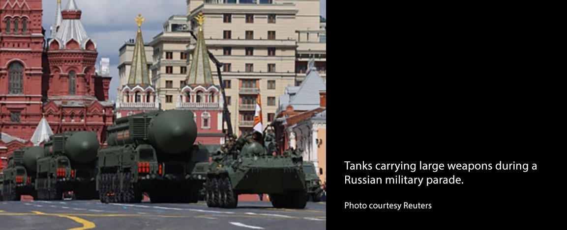 Tanks carrying large weapons during a Russian military parade.