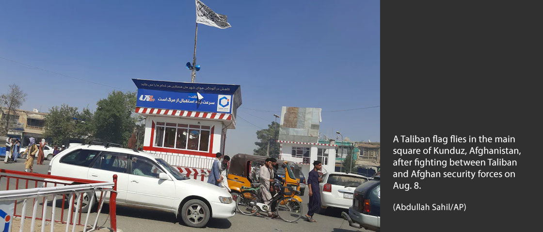 A Taliban flag flies in the main square of Kunduz, Afghanistan, after fighting between Taliban and Afghan security forces on Aug. 8. (Abdullah Sahil/AP)