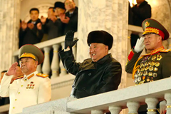 This photo taken on Jan. 14 and released by North Korea’s official Korean Central News Agency shows the country’s leader, Kim Jong Un, center, gesturing during a military parade. (KCNA/KNS/AFP/Getty Images)