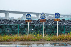 piles of garbage bags with signs in Japanese