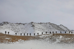 People hiking with mountains in distance, Feature China/Barcroft Media/Getty Images