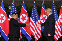Kim Jong Un shakes hands with President Donald Trump at the start of their historic U.S.-North Korea summit at the Capella Hotel on Sentosa island in Singapore on June 12, 2018. 