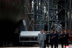 North Korean leader Kim Jong Un inspects a newly built submarine at an undisclosed location in this undated picture released Tuesday. | REUTERS