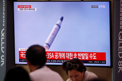 People watch a TV screening of a file footage for a news report on North Korea firing a missile that is believed to be launched from a submarine, in Seoul, South Korea, October 2, 2019. REUTERS/Kim Hong-Ji