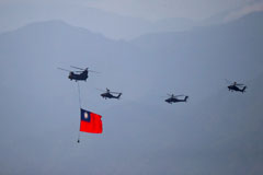 Military helicopters carrying a Taiwan flag fly near the Taipei 101 building as part of a rehearsal ahead of a Double Tenth Day celebration in New Taipei City, Taiwan, on Tuesday. Photo by Ceng Shou Yi/NurPhoto via Reuters Connect
