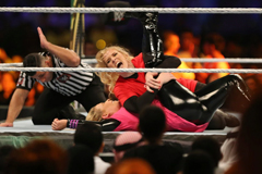 Lacey Evans taking down Natalya Neidhart in the first-ever WWE women’s match in Saudi Arabia, in Riyadh, on Halloween.Credit...Amr Nabil/Associated Press