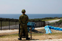 soldier standing guard overlooking ocean