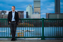 Rich Nielsen in front of Charles River with Boston Skyline