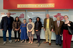 A group photo in front of the exhibit sign