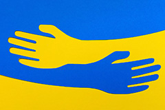 Helping hands in Ukraine flag colors