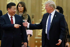 Donald Trump talked to China's President Xi Jinping as Trump and First Lady Melania Trump arrived for a state dinner at the Great Hall of the People in Beijing on Nov. 9.