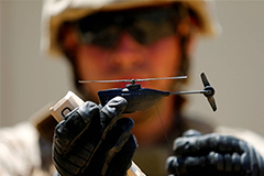 A U.S. Marine shows off a Grp I UAS Black Hornet drone as part of the Rim of the Pacific 2016 exercise at Camp Pendleton, California, in July 2016. | REUTERS