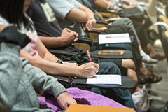 Image of people at meeting taking notes