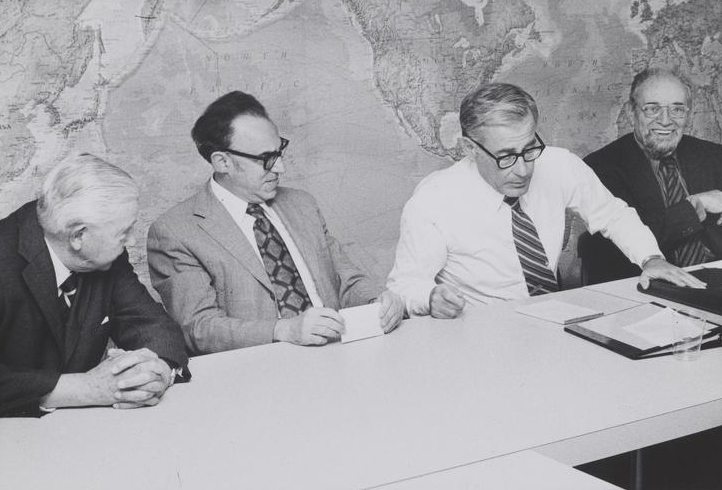 Black and white photograph of (from left) James R. Killian, Jack P. Ruina, Defense Secretary Harold Brown, and an unidentified man seated at a table for a panel discussion