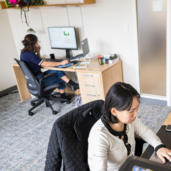 Two CIS researchers on their computers in their office